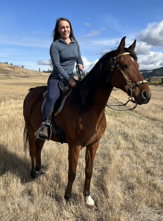 woman riding an Arabian horse