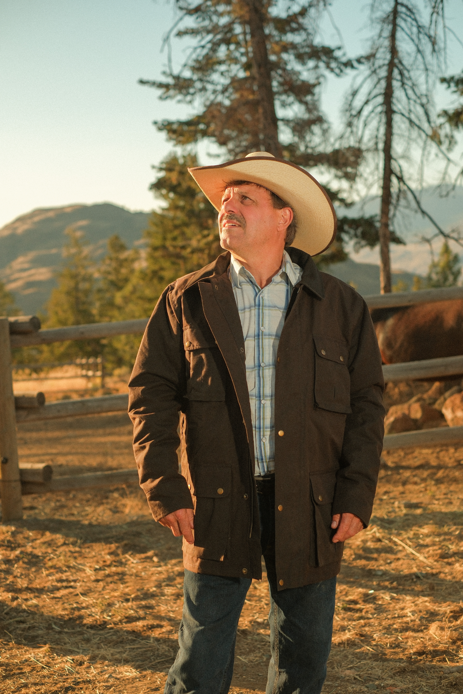 Man standing in an oilskin brown coat
